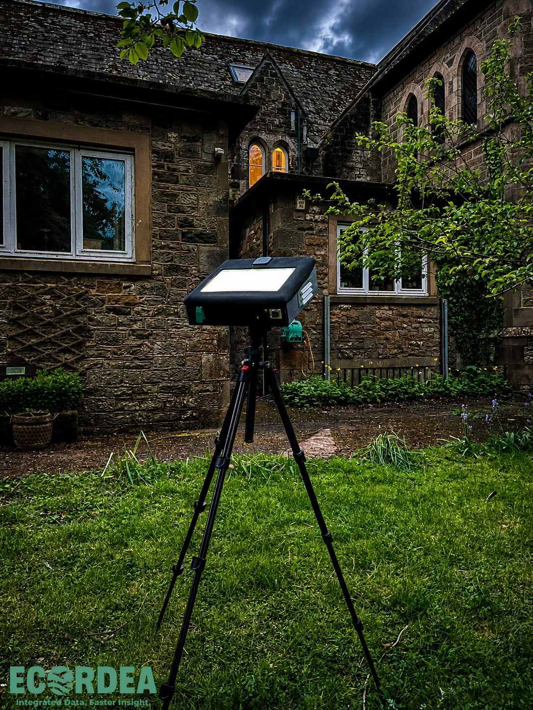 DarkFlight deployed at dusk in front of a stone church, its screen glowing